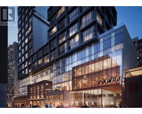 A modern building with a large glass facade and a sign that reads "NOBU".