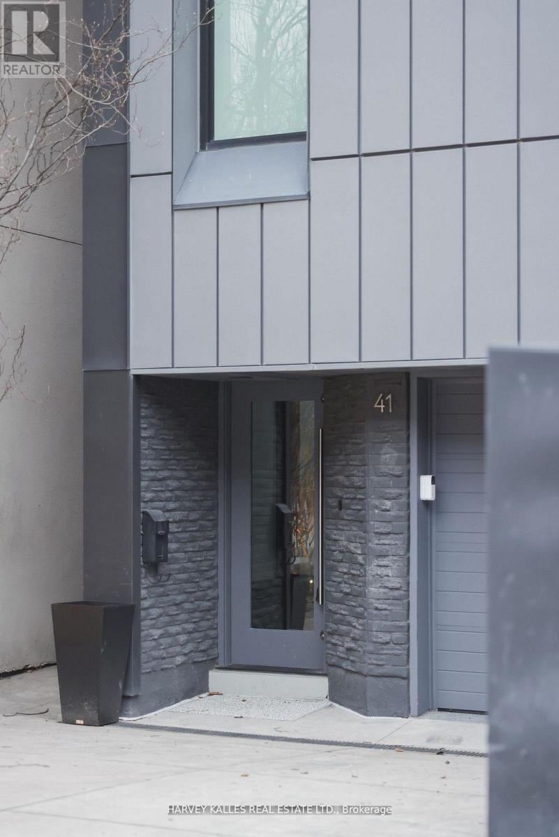 A modern building with a grey facade and a door numbered 41.