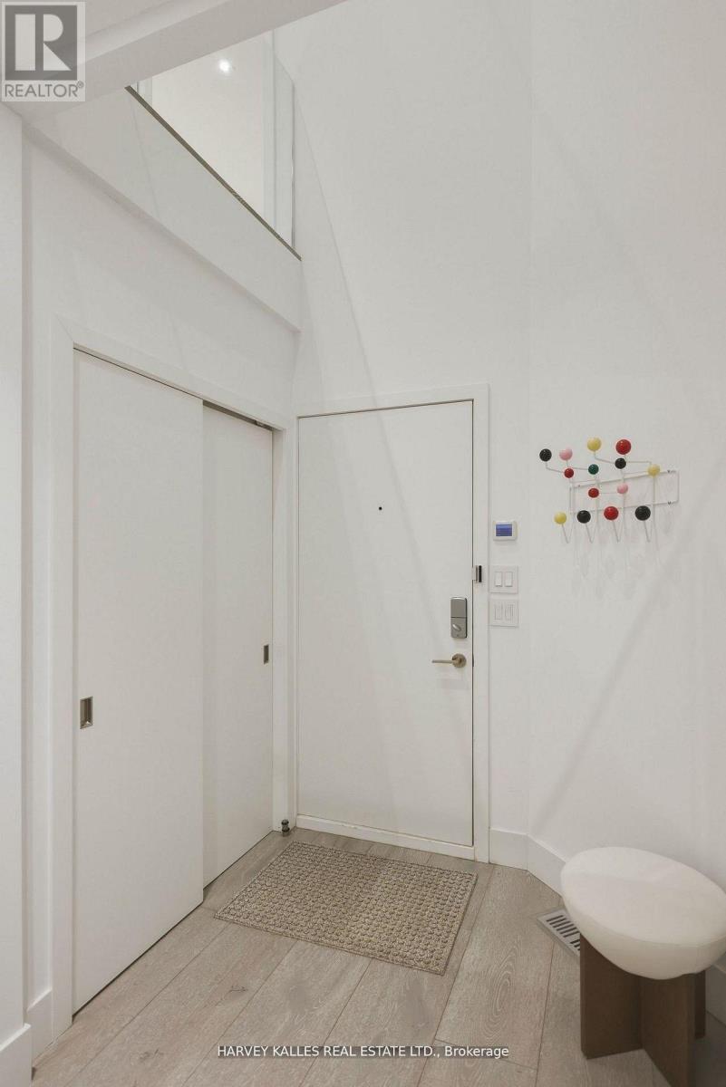 A white door with a handle and a small round table next to it.