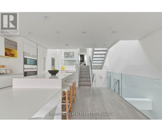 A modern interior space with a staircase leading to the upper level.