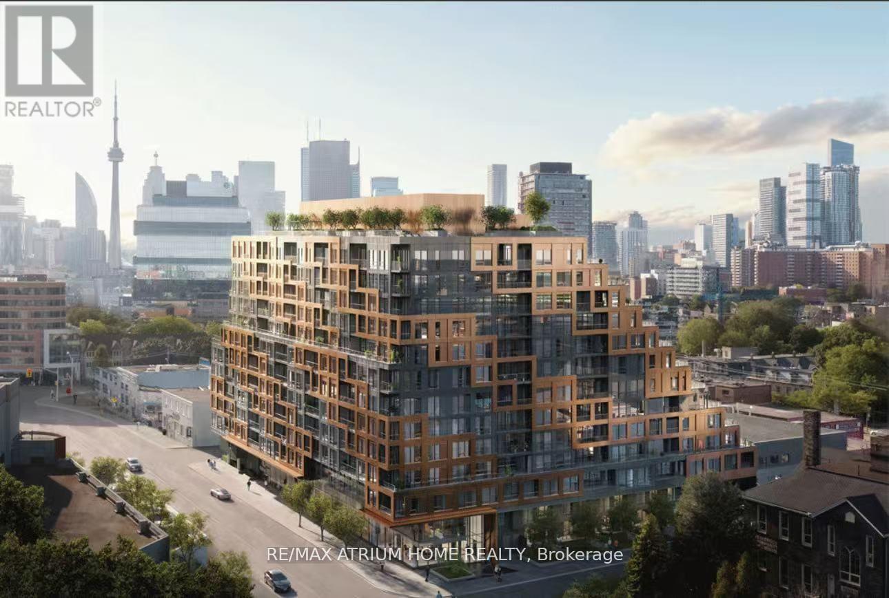 A modern multi-story residential building with balconies and greenery on the roof is under construction.