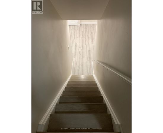 A long flight of stairs leading to a bright room.
