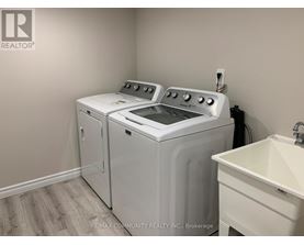 A white washer and dryer in a laundry room.