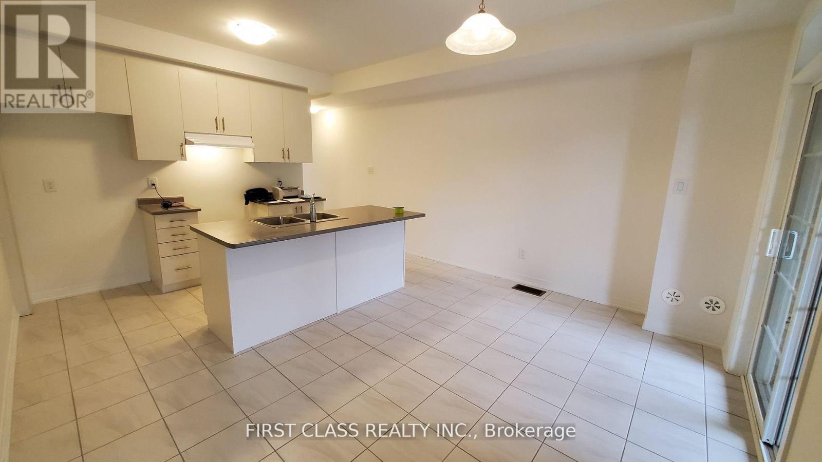 A kitchen with white cabinets and a countertop.