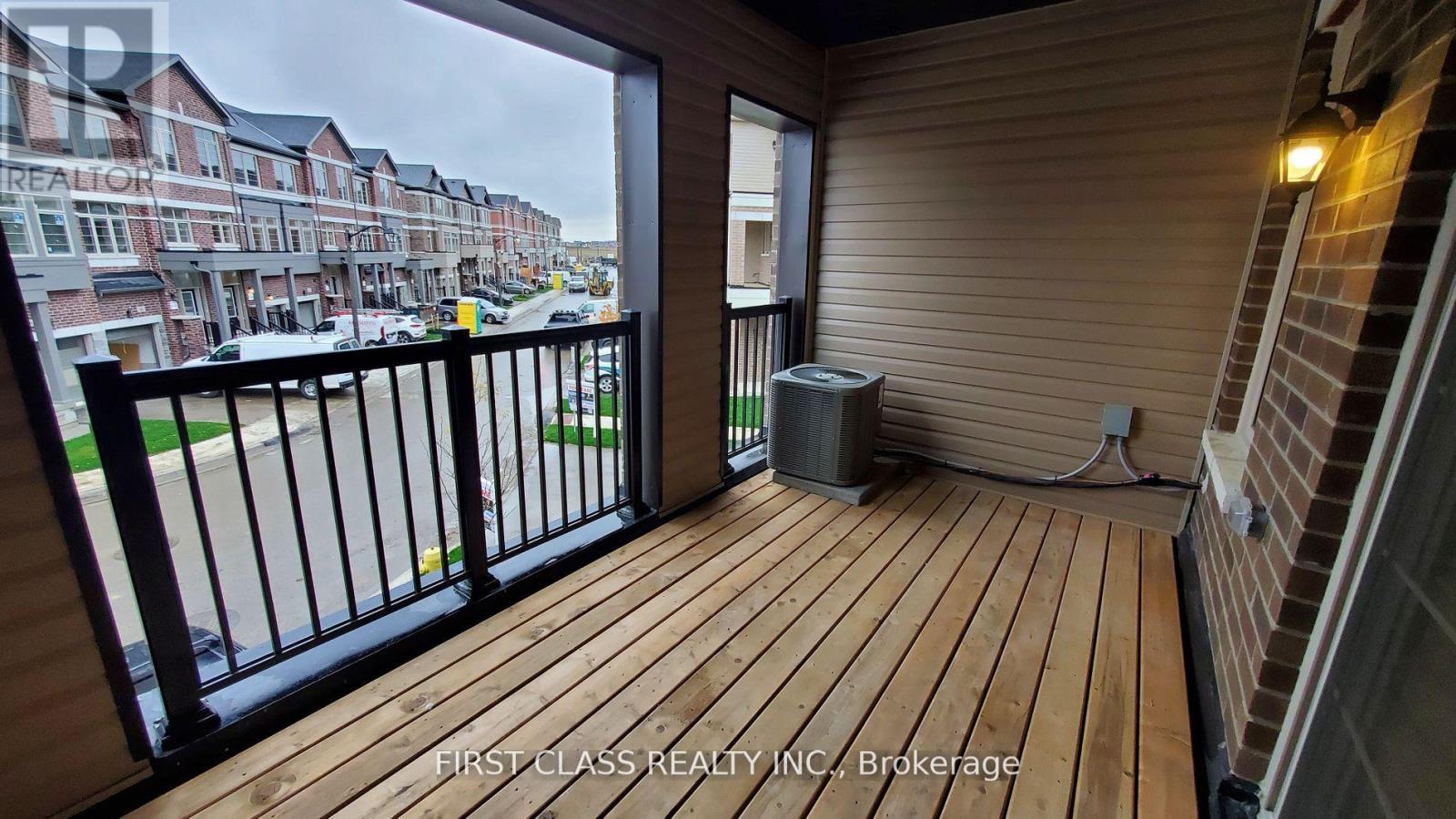A balcony with a view of a street and buildings.
