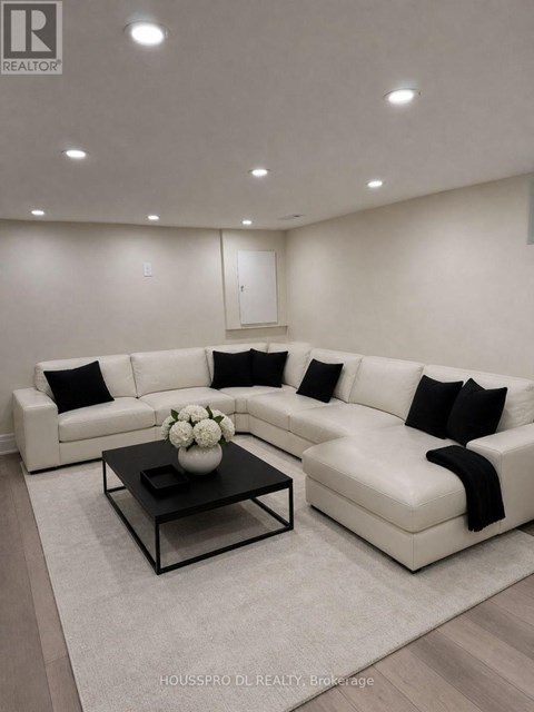 A modern living room with a white sofa and a coffee table.