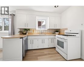 A white kitchen with a stove and cabinets.