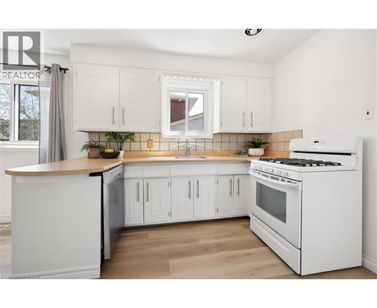 A white kitchen with a stove and cabinets.