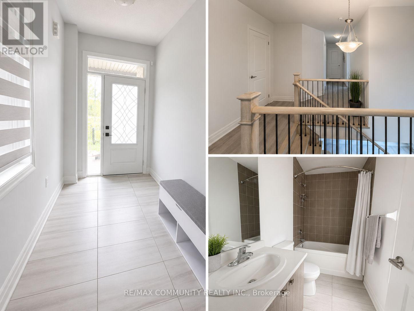 A white interior of a house with a door, a staircase, and a bathroom.