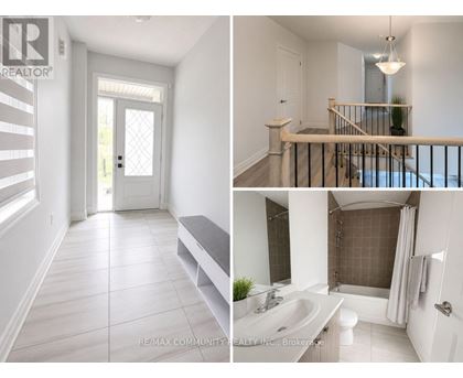 A white interior of a house with a door, a staircase, and a bathroom.