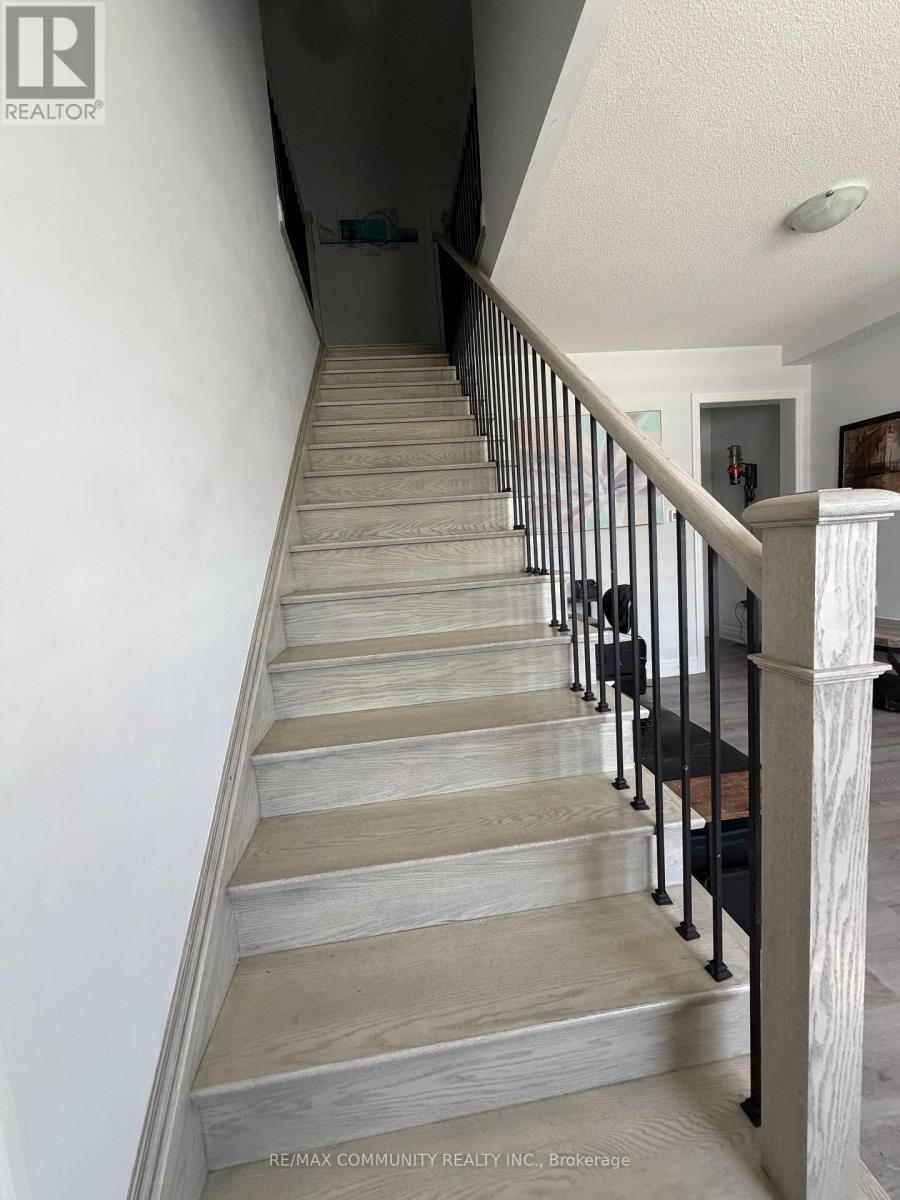 A staircase with wooden steps and black handrails.
