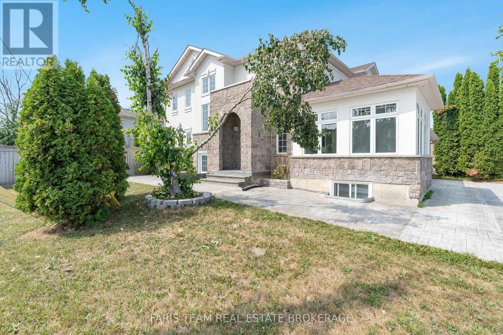A house with a large front yard is for sale.