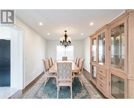 A dining room with a table set for six.