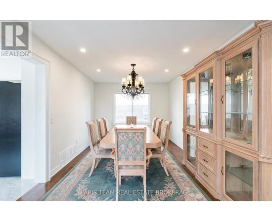 A dining room with a table set for six.