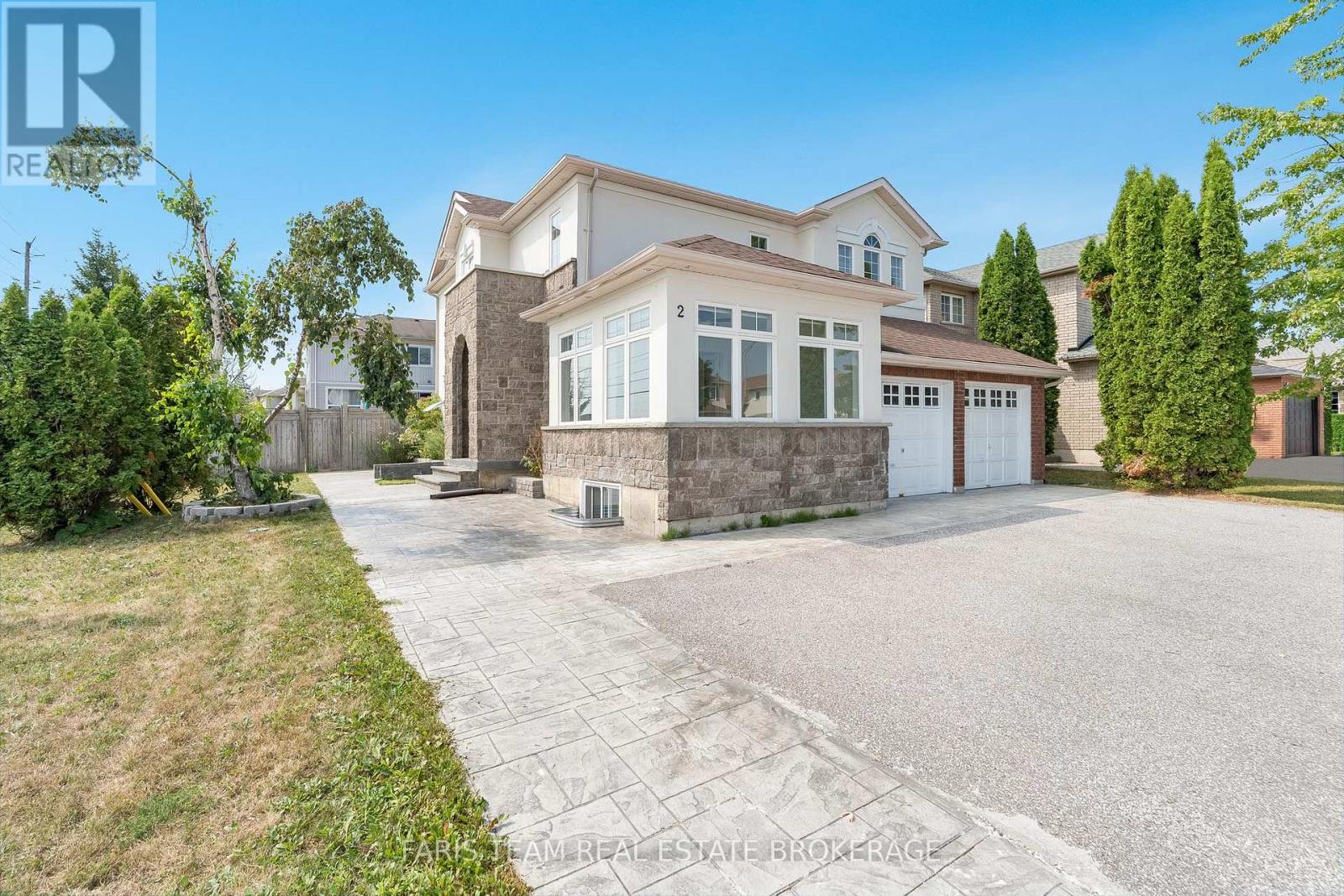 A large house with a driveway in front of it.