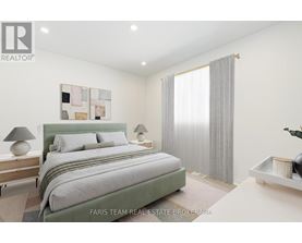 A bedroom with a large bed and a painting on the wall.