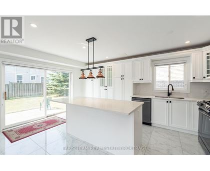 A kitchen with white cabinets and a large island.