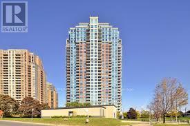 A tall blue and white building with the logo REALTOR on the top left corner.