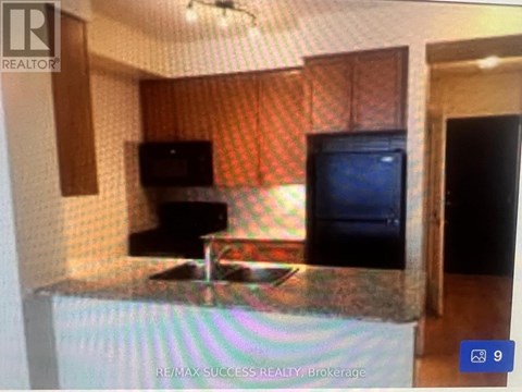 A kitchen with a counter and a microwave.