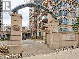 A building with a stone archway entrance and a sign that reads "NUVO".