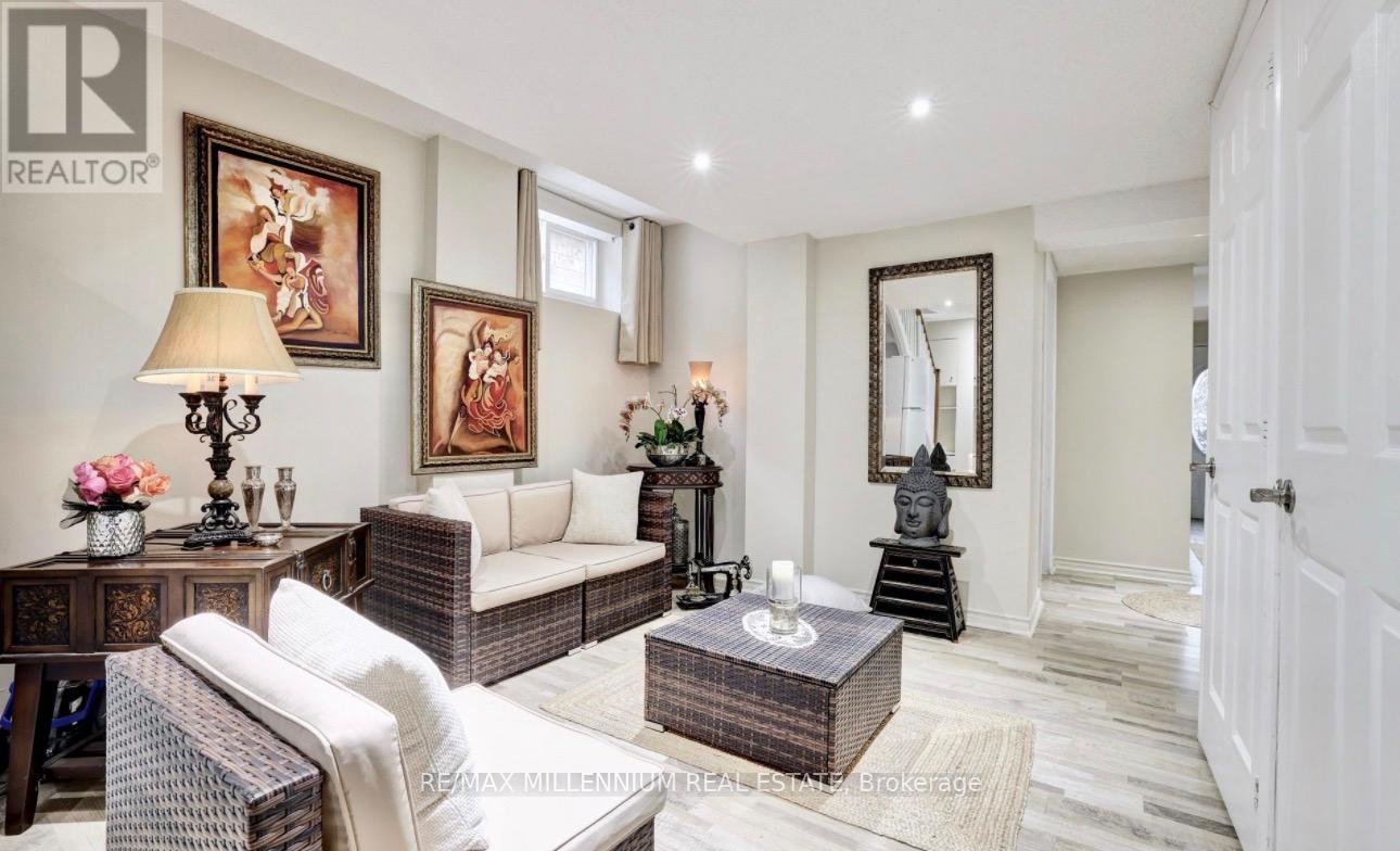 A well-lit living room with a sofa, armchair, and coffee table.