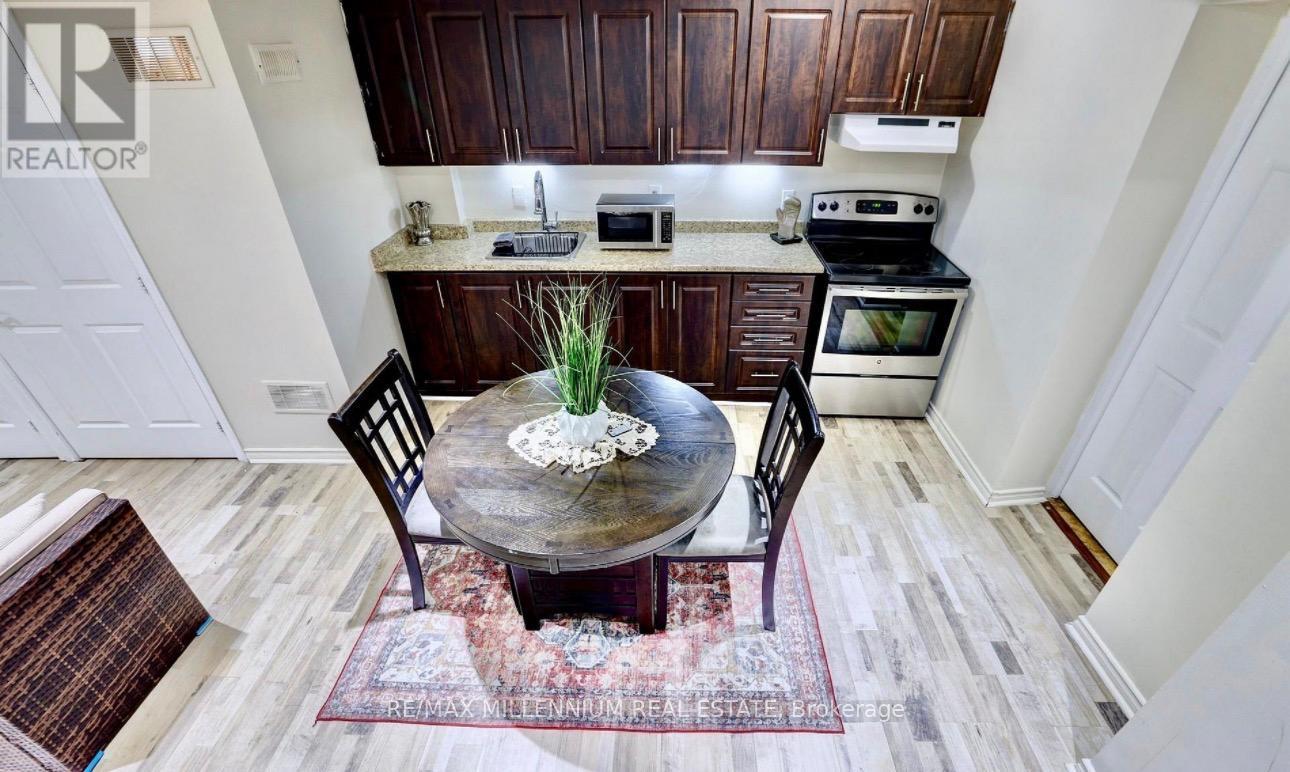 A kitchen with a table and chairs in the middle of the room.