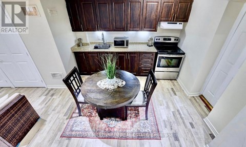 A kitchen with a table and chairs in the middle of the room.