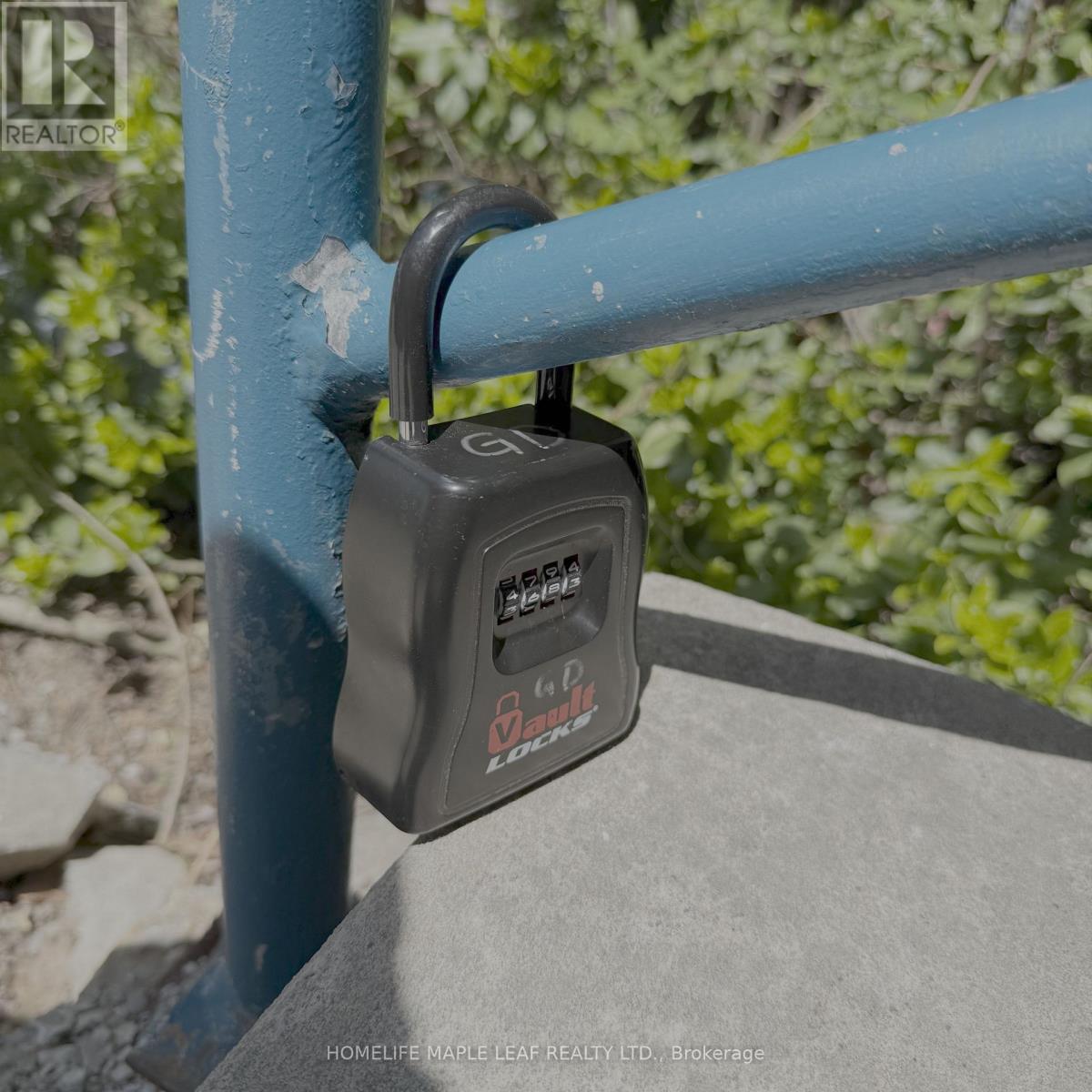 A padlock is attached to a blue metal post.