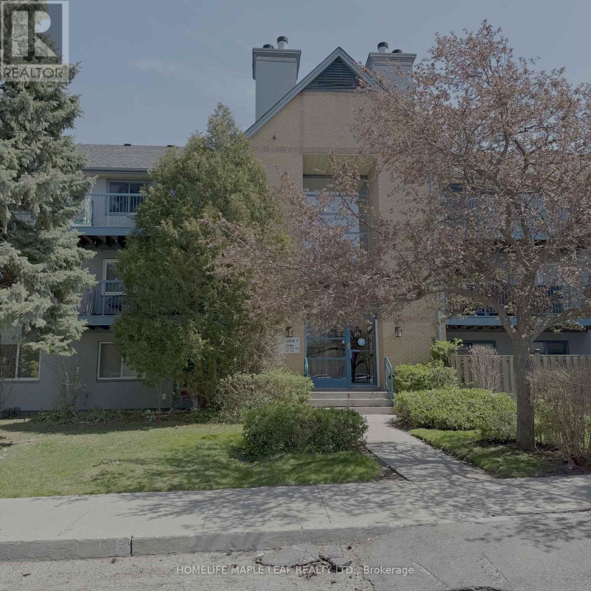 A realtor sign is in front of a building.