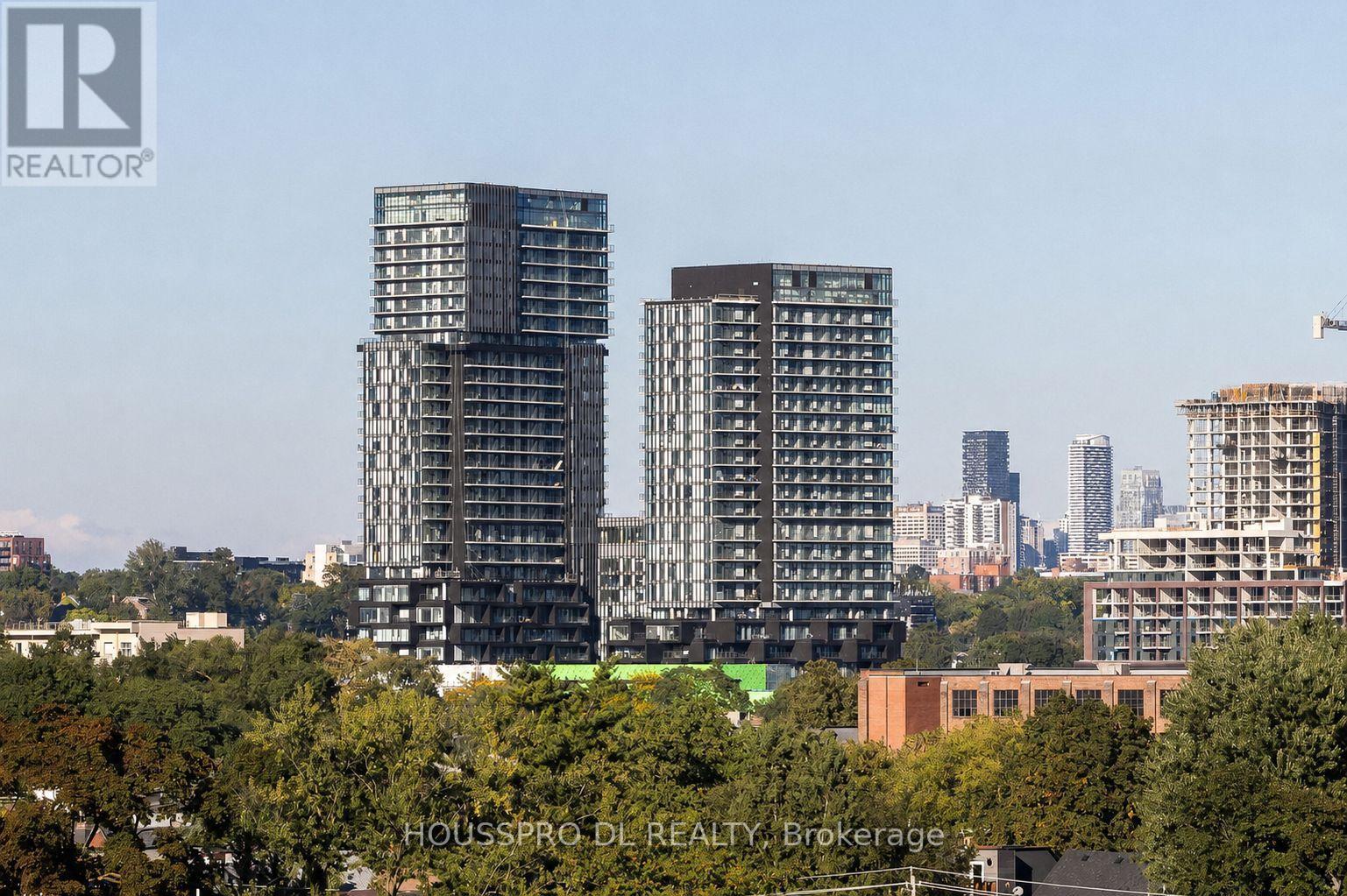 Two high-rise buildings are seen in the foreground with a city skyline in the background.