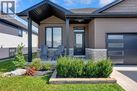 A house with a brown roof and a grey garage door.