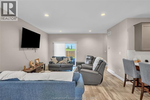 A living room with a blue couch and a television.