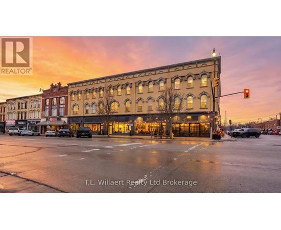 A street view of a building with the sign T.L. Willaert Realty Ltd Brokerage.