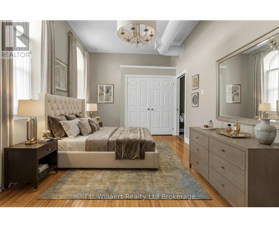 A bedroom with a large bed, a dresser, and a mirror.
