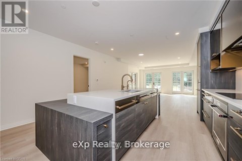A modern kitchen with a large island and stainless steel appliances.