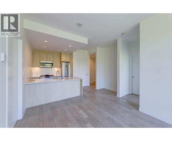 A modern kitchen with a wooden countertop and a sink.