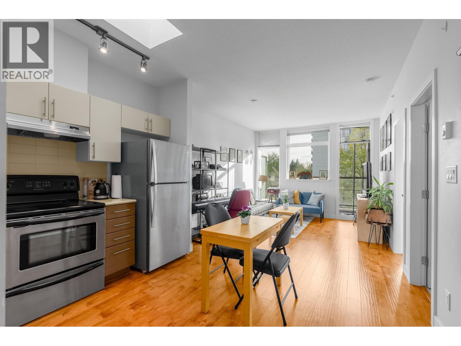 A modern kitchen with a dining table and chairs.