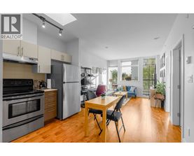 A modern kitchen with a dining table and chairs.