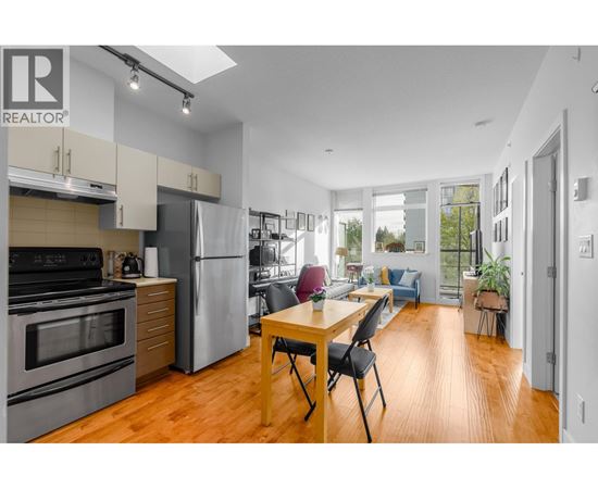 A modern kitchen with a dining table and chairs.