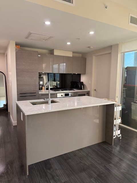 A modern kitchen with a large island and a sink.