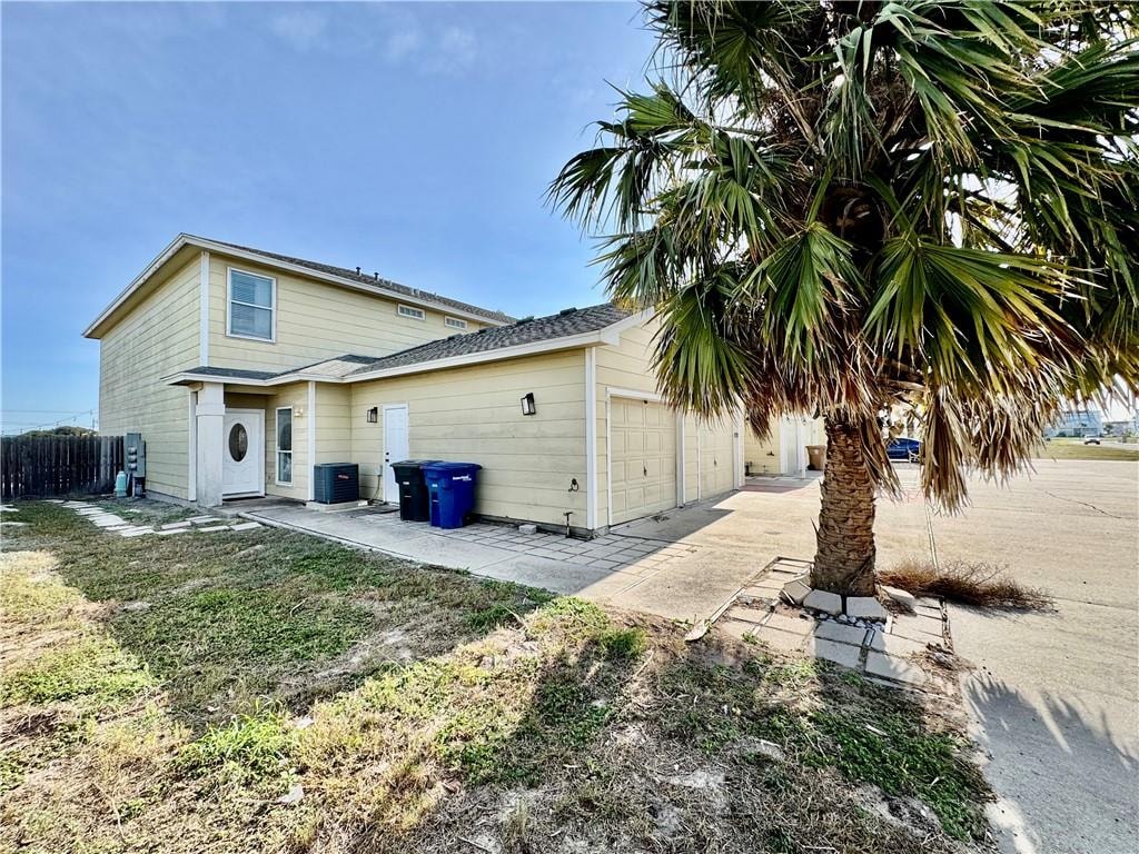 A house with a palm tree in front.