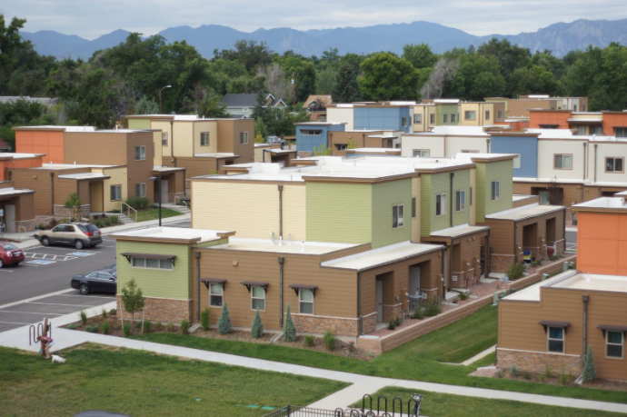 A row of houses with a mountain in the background.