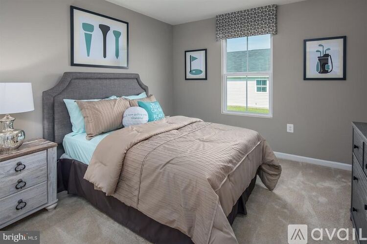 A bedroom with a bed, dresser, and two pictures on the wall.