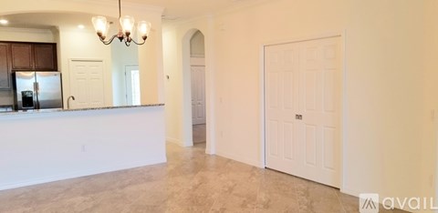 A kitchen with a white counter and a chandelier.