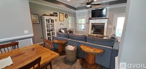 A living room with a wooden table and a blue couch.