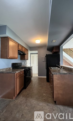 A kitchen with copper appliances and brown cabinets.