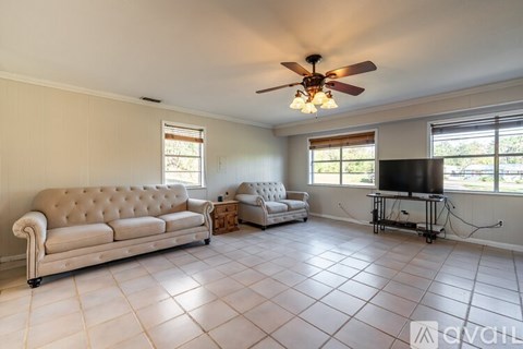 A living room with a beige sofa and a television.