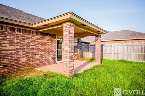 A brick house with a covered walkway leading to the front door.