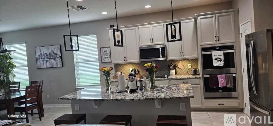 A kitchen with granite countertops and stainless steel appliances.