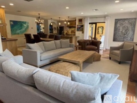A living room with a grey couch and a wooden coffee table.